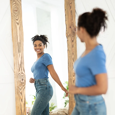 Woman Happy With Weight Loss Results Looking In the Mirror