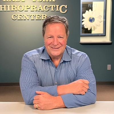 Chiropractor Richard Green Smiling At Front Desk