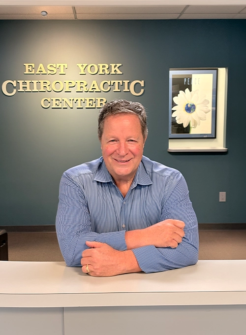 Chiropractor Richard Green At Front Desk Smiling
